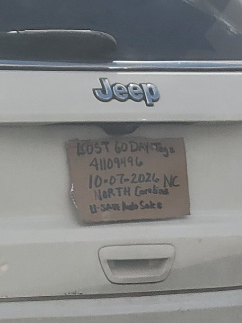 Close-up of a handwritten cardboard North Carolina temporary plate