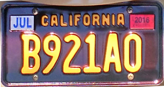 Modern California 1960s Legacy license plate, a newly manufactured black plate with yellow characters
