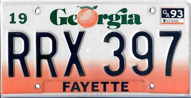 1990 Georgia Peach graphic license plate, black characters on a white background with a large peach graphic