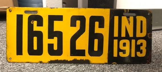 Early Indiana license plate from the 1910s, a yellow porcelain tag with a black serial number