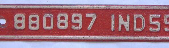 Mid-century Indiana annual license plate with a two-letter county prefix and four-digit serial